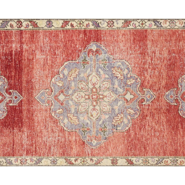 Handwoven vintage Turkish Oushak runner measuring 3'10" x 10'8". Crafted with wool on wool foundation in Western Turkey's...