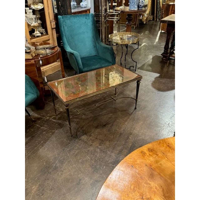 Beautiful mid 20th century French Maison Jansen brass coffee table. Featuring a chinoiserie design on the top. Gorgeous!!...