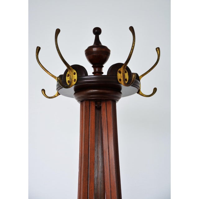 Fine quality jas shoolbred figured and solid walnut coat stand, having five original double hooks in brass on revolving...