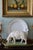 A wonderfully sculptural vintage grazing sheep, hand-painted in time-softened antique ivory and mounted on its original...