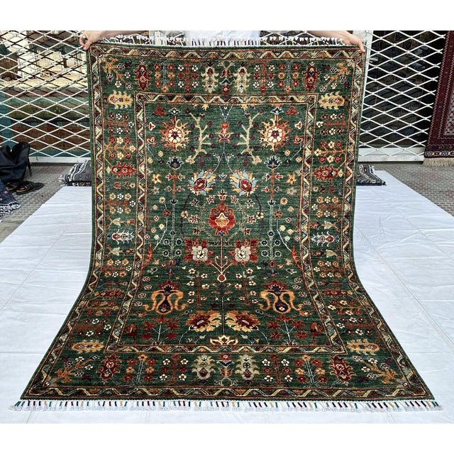 Persian Oushak design hand-knotted rug featuring a luminous antique green field scattered with large-scale floral sprays,...