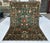 Persian Oushak design hand-knotted rug featuring a luminous antique green field scattered with large-scale floral sprays,...