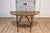 An Italian Baroque period walnut console table from the 17th century with carved lyre-shaped base. This Italian Baroque...