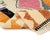 A playful gallery of abstract symbols floats across a soft ivory field — diamonds, chevrons, and totem-like forms rendered...