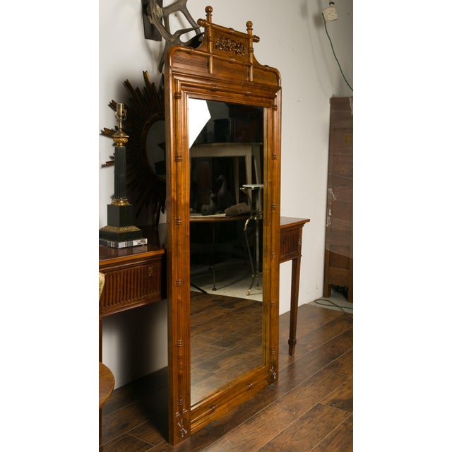 A large English faux-bamboo walnut mirror made from old doors from the early 20th century, with carved ivy motifs....