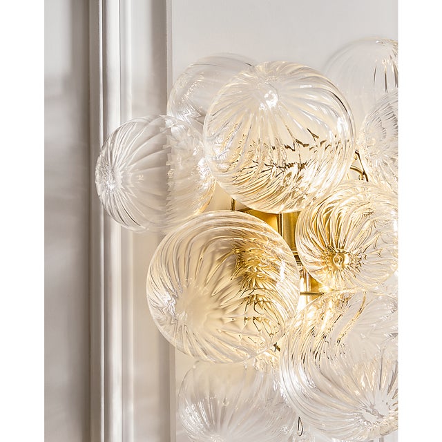 Description: Artisanal glass elevates the Talia series by Julie Neill, offering a new take on the simple glass globe light...