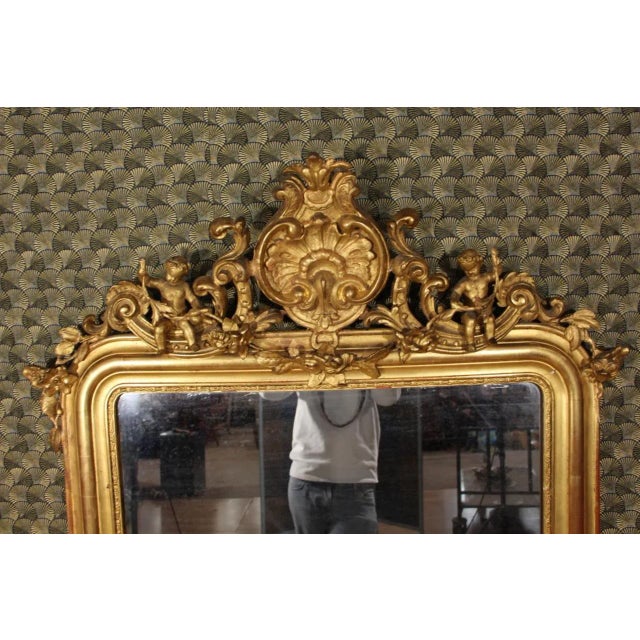 Louis Philippe period mirror, from Italy. The frame is entirely gilded with gold leaf. The mirror is original.