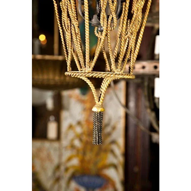 Gilt metal rope and tassel pendant light with four bulbs. Perfect for an Italian style home.