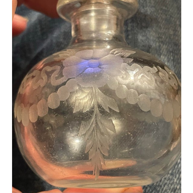 This is a sweet little crystal bottle with a lovely cut floral and swag pattern around the outside, the bottle is acid...