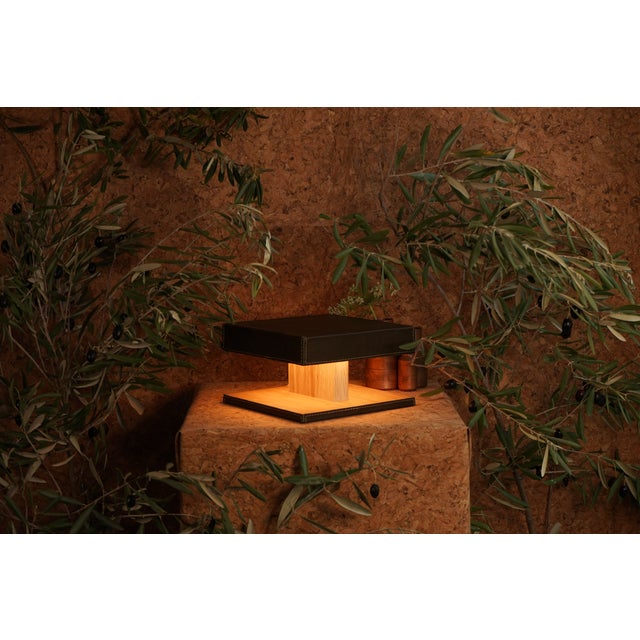 This table lamp was designed as a small architectural object—quiet, warm, and intentional. The form is compact and...