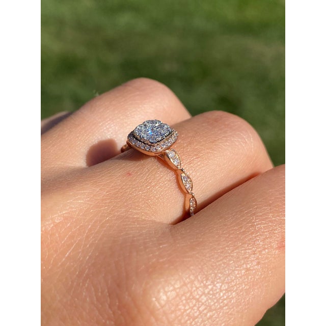 The Kanna: Ladies Rose Gold Pave Diamond Halo Engagement Ring. Crafted in rose gold, this contemporary engagement ring...