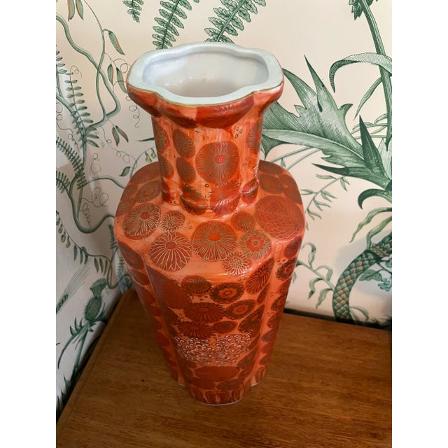 This is a lovely vase in an orange shade of salmon - such an unusual color. The trim and florals are gold and the design...