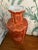 This is a lovely vase in an orange shade of salmon - such an unusual color. The trim and florals are gold and the design...