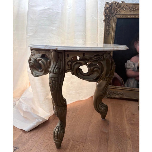 Beautiful matching pair of vintage Rococo Revival style side tables featuring ornate sculptural bases with elaborate...