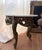 Beautiful matching pair of vintage Rococo Revival style side tables featuring ornate sculptural bases with elaborate...