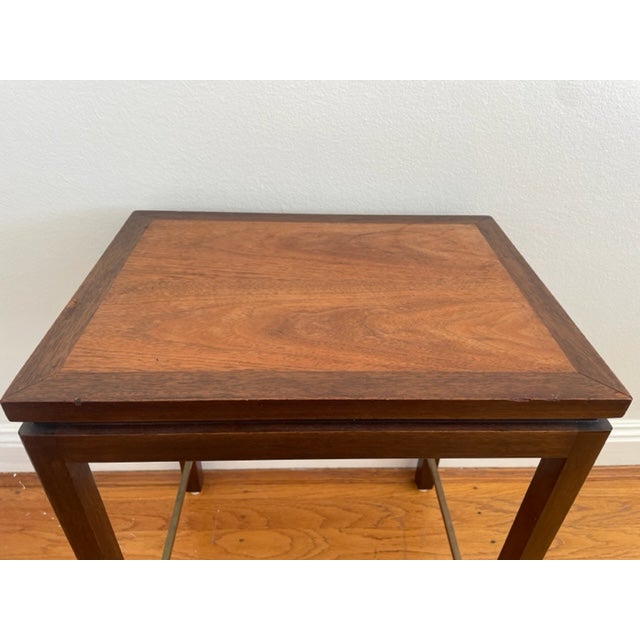 Rare walnut and mahogany end table with brass stretchers made by Edward Wormley for Dunbar with original label.