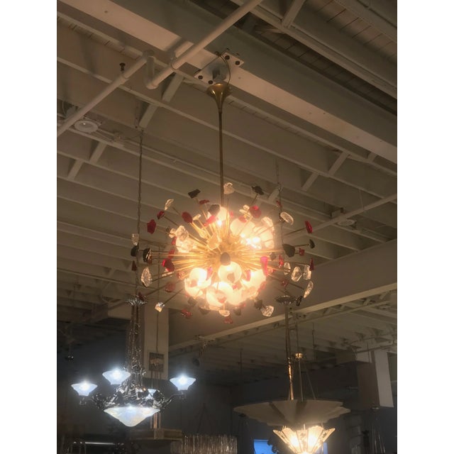 Beautiful Italian Mid Century Sputnik chandelier, having numerous individually multicolor glass suspended on rods. Height...