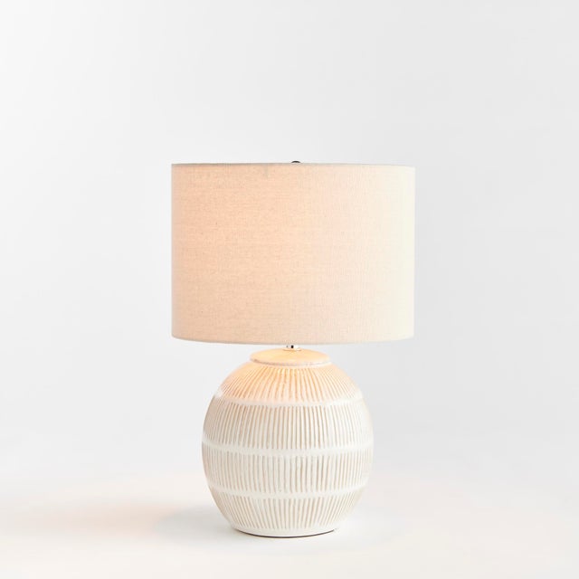With a rounded ceramic body and a hatch mark pattern, this lamp adds a bit of character to any setting. Topped off with a...