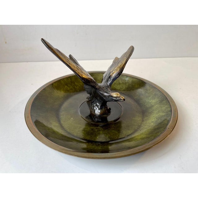 Circular bronze bowl with applied green verdigris patina (cold paint). Sculptural center figurine in shape of an eagle. It...