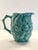 Beautiful ceramic serving pitcher set, with a fruit relief pattern throughout. The ceramic is in a celadon color and a...