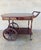 Elegant vintage tea and bar cart crafted in rich mahogany, dating from the 1940s. This refined serving trolley features...