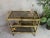 Vintage 80s bar trolley. Gold-colored sturdy frame on wheels. Fumigated glass. No chips or cracks. Bottle holder. Push...