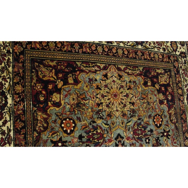 A very fine late nineteenth-century Persian Isfahan rug featuring an exceptionally intricate floral composition on a...