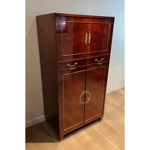 Empire style secretary in flamed mahogany and bronze locks. This is an Italian work in the style of Aldo Tura. Circa 1970