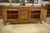 An elegant low oak sideboard, typical of the Art Deco aesthetic of the 1940s, blending geometric lines and balanced...
