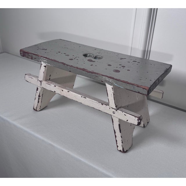 This is likely an late 19th to early 20th century small antique painted wooden low stool offering a Scandinavian Folk Art...
