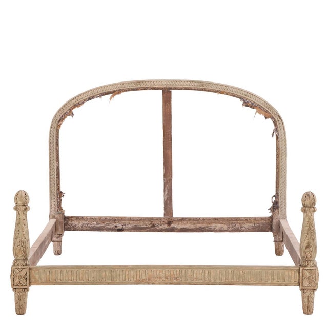 This Louis XVI French wooden bed frame features a classic European silhouette with an open, arched headboard. It showcases...