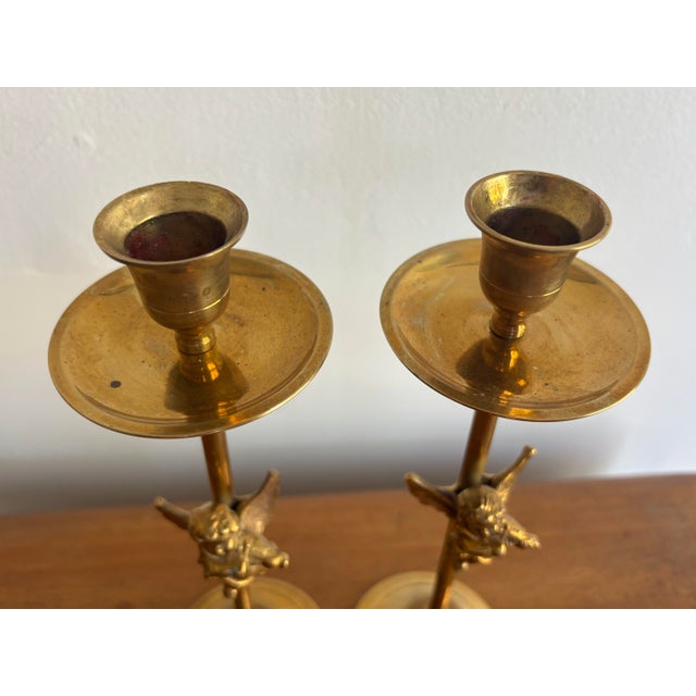 Late 20th century brass cherub putti candlestick holders with a charming pair of cherub or putti on each stem. Most items...