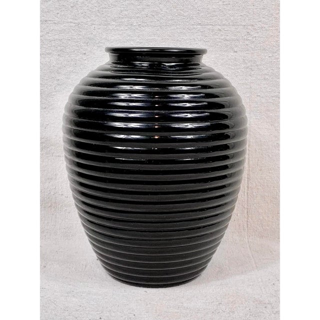 Add a striking graphic element to your shelf styling or tablescape with this fabulous vintage glossy black glass vase....