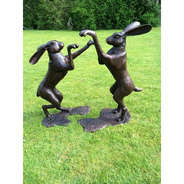 A wonderfully playful and impressive pair of oversized boxing hares, cast in bronze and finished with a rich cherry-brown...