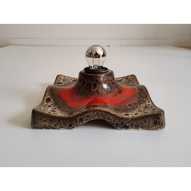 Fanstastic red, beige fat lava ceramic wall light manufactured by Hustadt Leuchten, Germany, 1970s. The light creates a...