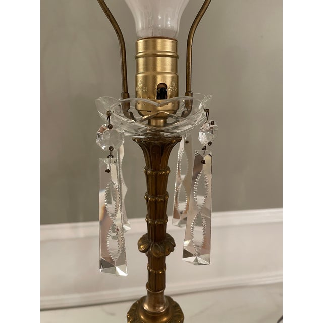 These are a one of a kind pair. Vintage brass with elaborate cut crystals adorn these lamps. Lamps sit of glass base...