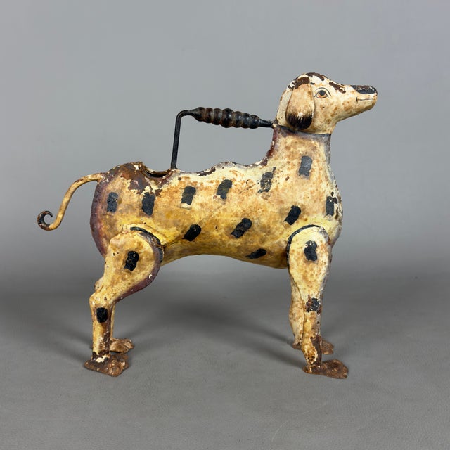 Original and evocative vintage watering can shaped like a dog, a unique functional sculpture in painted iron, attributed...