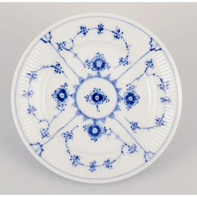 Royal Copenhagen Blue Fluted Plain. A set of four small lunch plates in porcelain\. Model number 1/179. Date: 1980-1984....