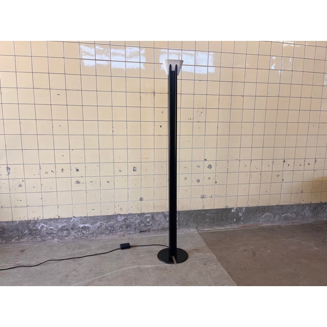 This Italian floor lamp from the 1980s is a striking example of postmodern design, featuring a bold graphic silhouette and...