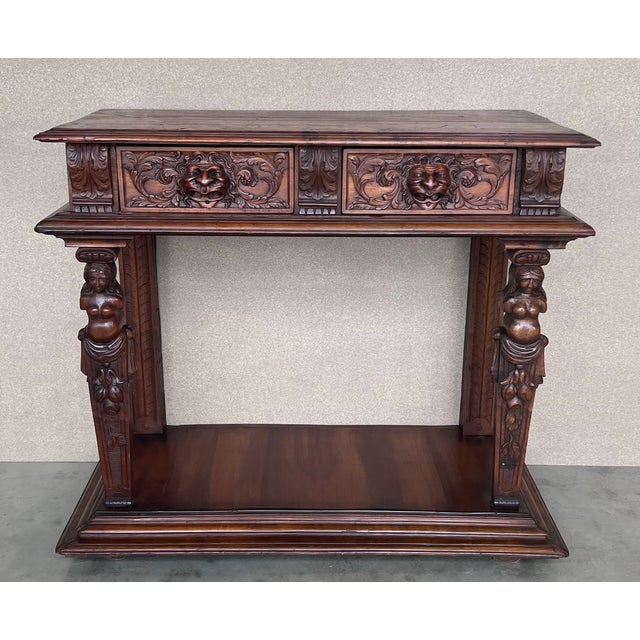 20th century console carved table Renaissance made of solid walnut wood It features carvings of mythological animals and...