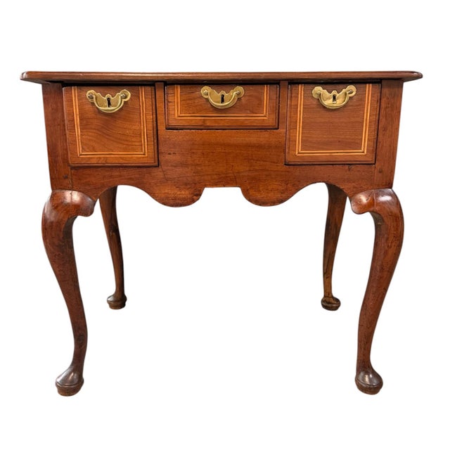 An exceptional English George III period walnut lowboy dressing table, dating to the late 18th century (circa 1770). The...