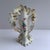 Strikingly sculpted vases with hand painted flowers and gold painted flourishing at every edge.