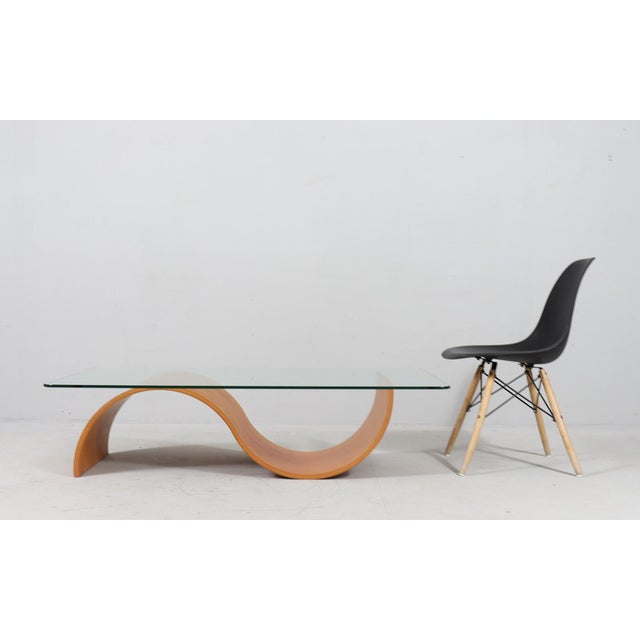 Organically shaped coffee table, Italy, 1980s, organic frame made of bent plywood, with a loose glass top, Dimensions...