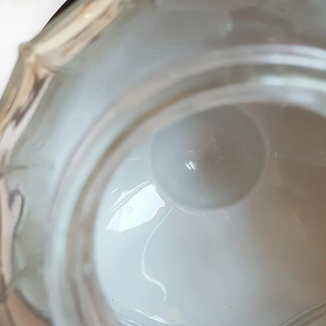 The lampshade is made of glass (also the black coloured top) This piece has an attribution mark, I am sure that it is...