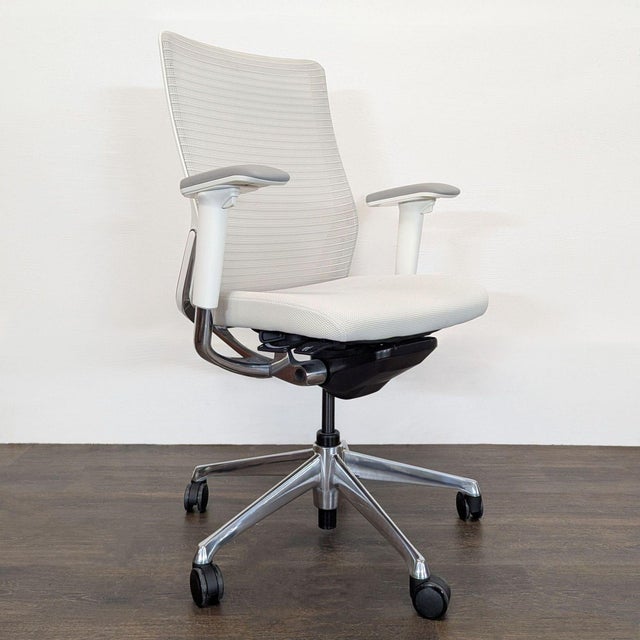 This Room & Board office chair features a clean, modern design with a white mesh back and seat for breathable comfort. The...