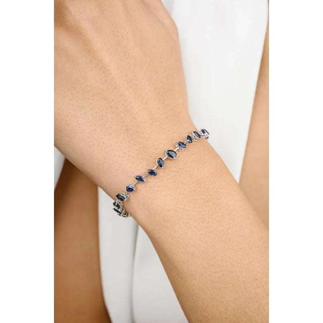 This is part of Chairish’s Fine Jewelry assortment. This Modern Natural Blue Sapphire Bracelet in 18K gold showcases...
