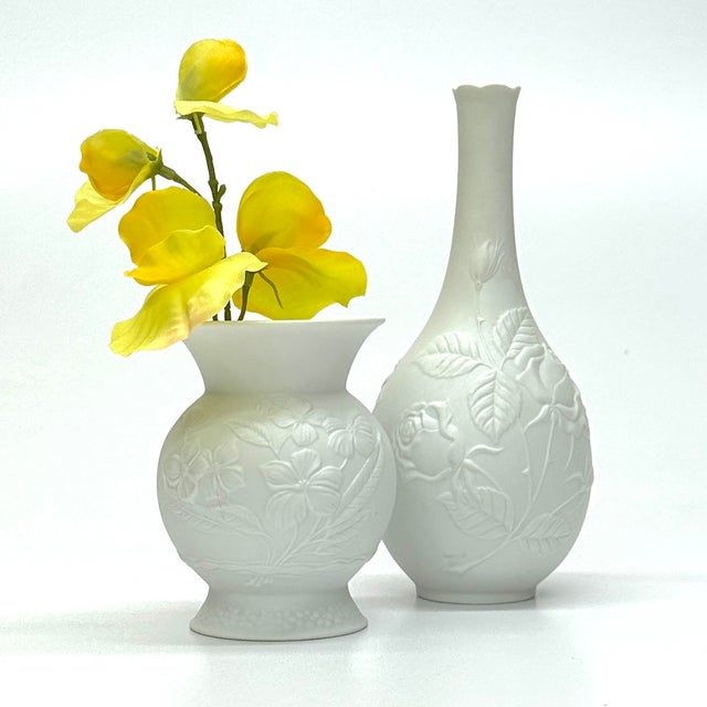 A delicate pair of 1980s bisque matte white porcelain floral relief Manfred Frey for Kaiser Germany. In excellent vintage...
