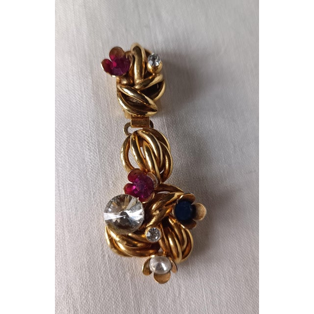 Drop earrings with brass clip closures and colored rhinestones. Made in Italy in the 1970s and 1980s.