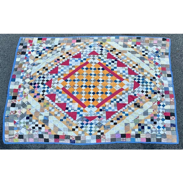 Arranged into a four-square diamond pattern, this is an amazing hand-stitched quilt made up of beautiful little swatches...