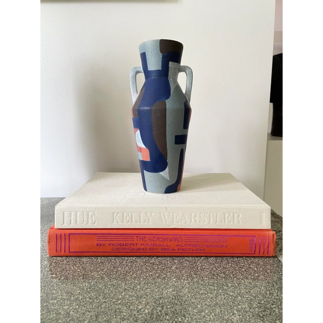 Hand painted urn style vase with geometric abstract shapes throughout. Hand painted in Southeast Asia. As this is a hand...